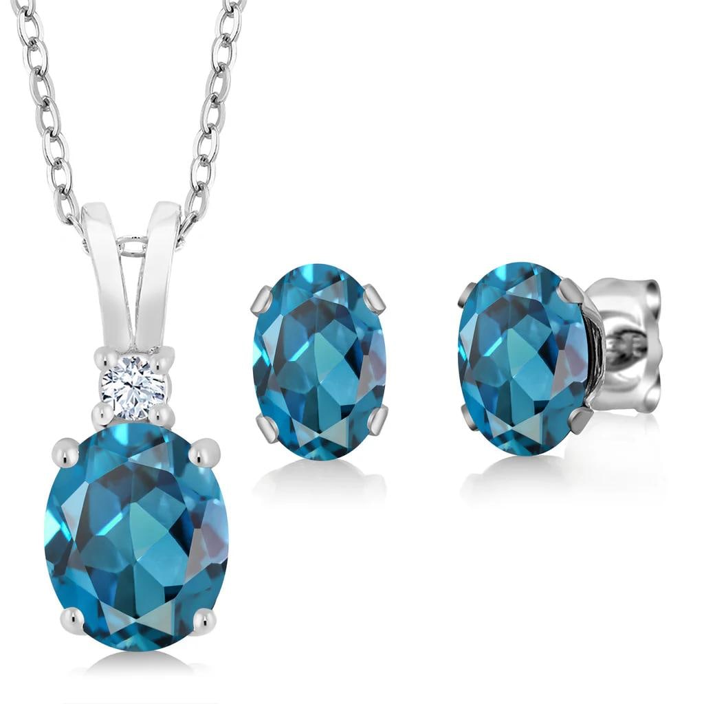Sterling Silver 3.15ctw London Blue Topaz Pendant and Earrings: 3.55cttw London Blue topaz and white zirconia design in solid 925 sterling silver, centered by a 1.50ct oval main stone with two 1.00ct oval accents and a crisp 0.05ct white zirconia highlight. VS cla