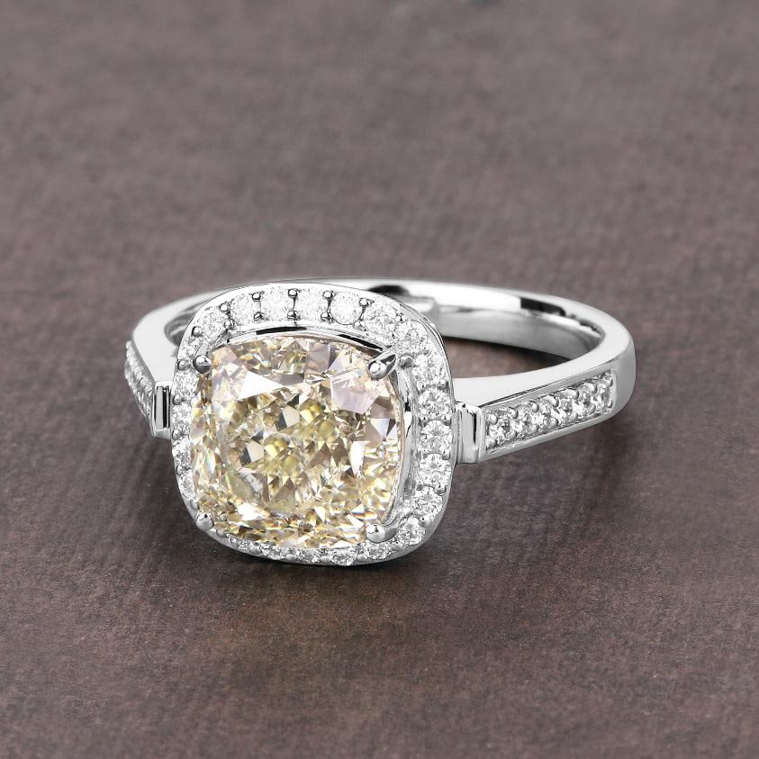 18KT White Gold 4.02ct Light Yellow Diamond Ring: Crafted in luxurious 18K white gold, this fine-finish statement ring is a striking showcase of natural diamond brilliance. At its center rests a rare 4.02 carat cushion-cut yellow diamond, measuring 8