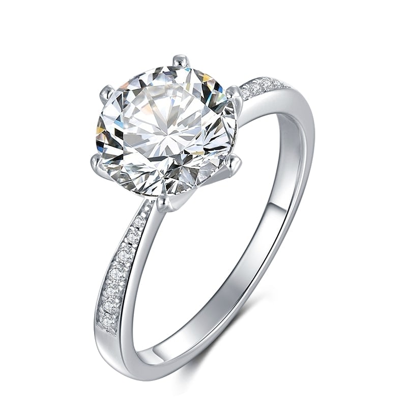 Ladies Sparkling 3 Ct White Fire Moissanite Ring: This Large 3 Ct Moissanite Centerstone is a VVS1 Brilliant 9 mm. Round Cut. The Color is White G-H. It is near flawless and bursting out with a full spectrum of colors. This Moissanite Ring is complim