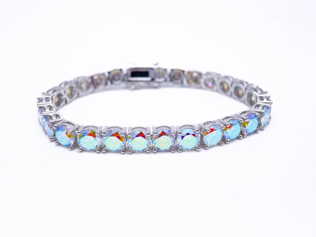 Plated 18KT White Gold 27 Ctw Azotic Blue Fire Moissanite Tennis Bracelet: 18 Kt White Gold Plated Huge 27 Ctw Azotic Blue Fire Moissanite Tennis Bracelet. These 27 Individual Azotic Moissanites are VVs1 Brilliant Round Cuts measuring 6.5mm. They burst out with a full spectr
