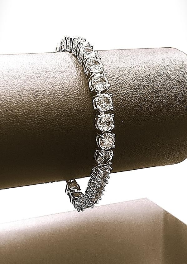 18 K White Gold Plated Simulated 26 Cwt. Diamond Tennis Bracelet: White Gold Plated Lab Simulated 26 Cwt. White Diamond Bracelet These 26 Gemstones are Brilliant Round Cuts Measuring 6.5 mm. They are Mounted In White Gold Overlay. Approx 7 " long.