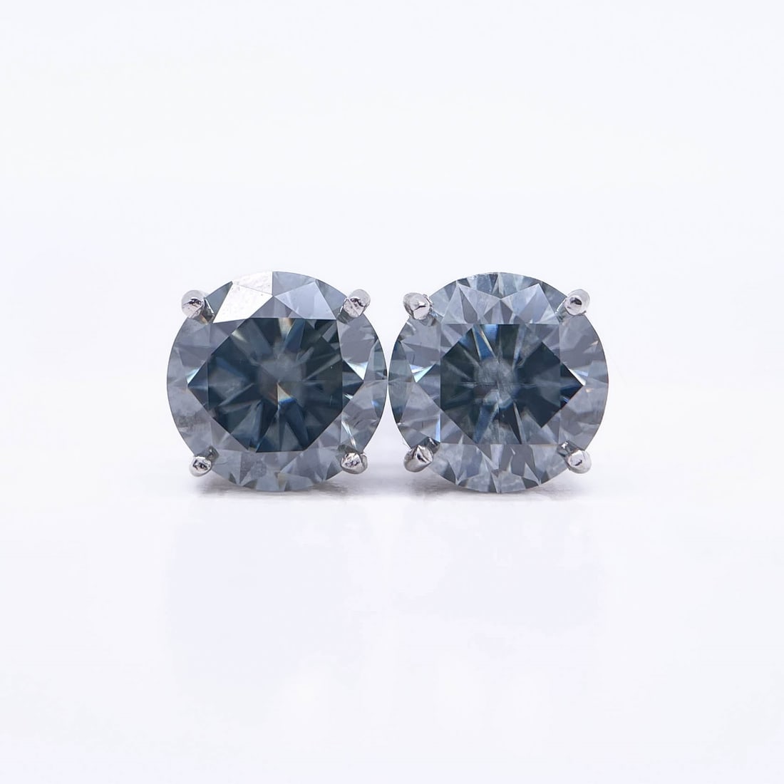 Plated 14KT White Gold 4.00ctw Steel Blue Gray Moissanite Earrings: These Beautiful Large 4 Cttw Striking Steel Blue Gray Fire Moissanite Earrings are eye-clean and bursting out with a full spectrum of Colors. They are Brilliant Round Cuts Measuring Approx 8 mm each a