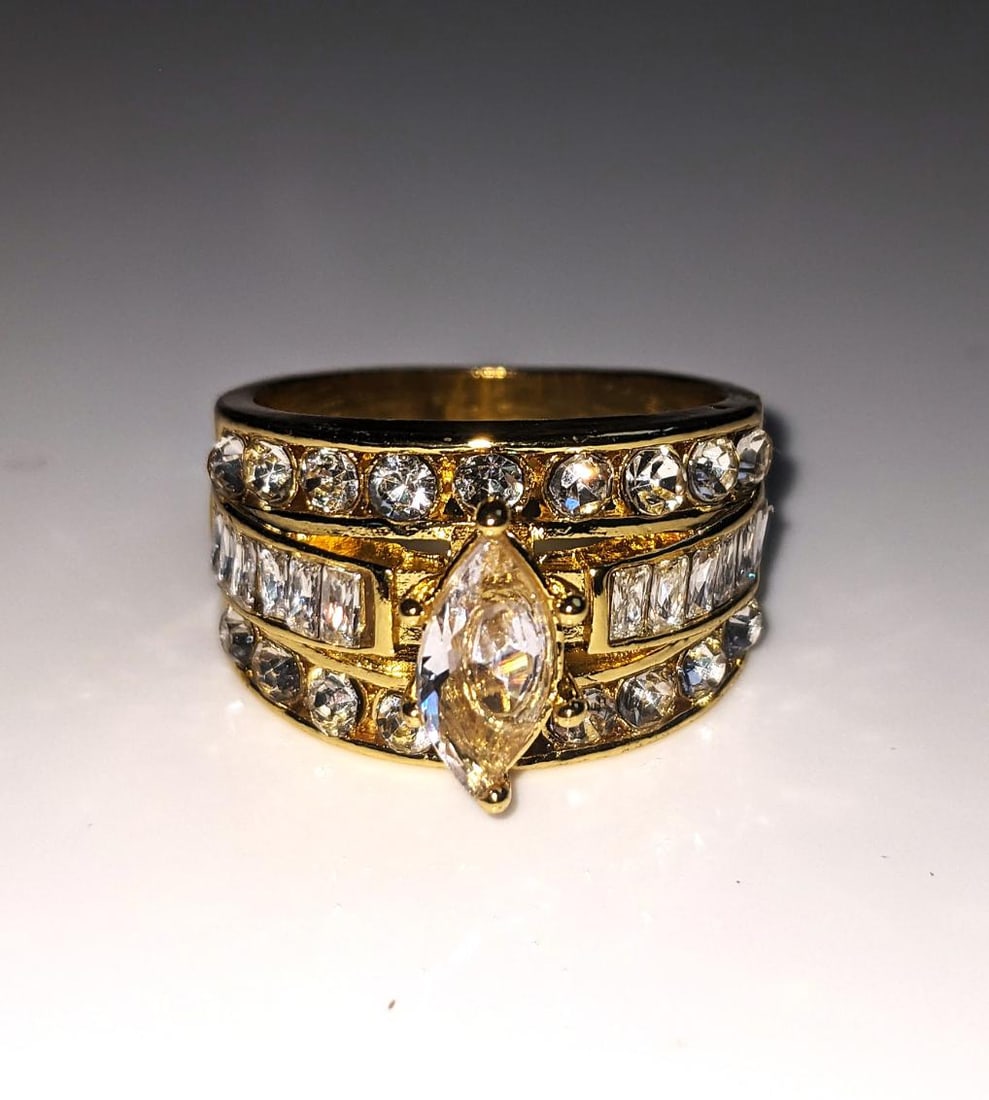 14KT Gold Plated Marquis Cut Lab Simulated Diamond Ring: Ladies Sparkling 14 Kt Yellow Gold Plated 5 Cwt. Marquis Cut Lab Simulated Diamond Ring. This 3.35 Ct VVs1 Eye Clean Rare Marquis Cut Centerstone is complimented by 10 Fancy Baguette Cuts and 12 Brill
