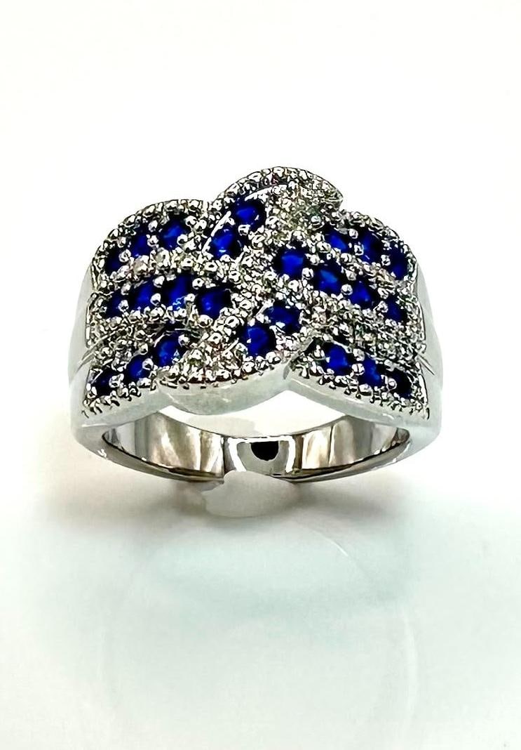 Plated 14KT White Gold 7 Ctw Simulated Blue Sapphire Ring: Stunning 14 Kt White Gold Plate 7 Cttw Midnight Blue Simulated Sapphire Ring. These 26 individual count Blue Sapphires are eye clean Brilliant Round Cuts. They are Mounted in 14 Kt White Gold Plate wh
