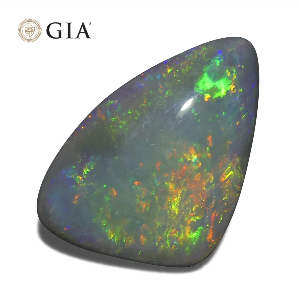 Large Rare 6.39 Ct GIA Certified Natural Opal: Unique 6.39 Ct Freeform Gray Opal measuring 17.89 x 12.12 x 5.48 mm. Displays a stunning play of color with a light tone. Do not miss this one! Origin: Australia. Treatment: None. Please see the certi