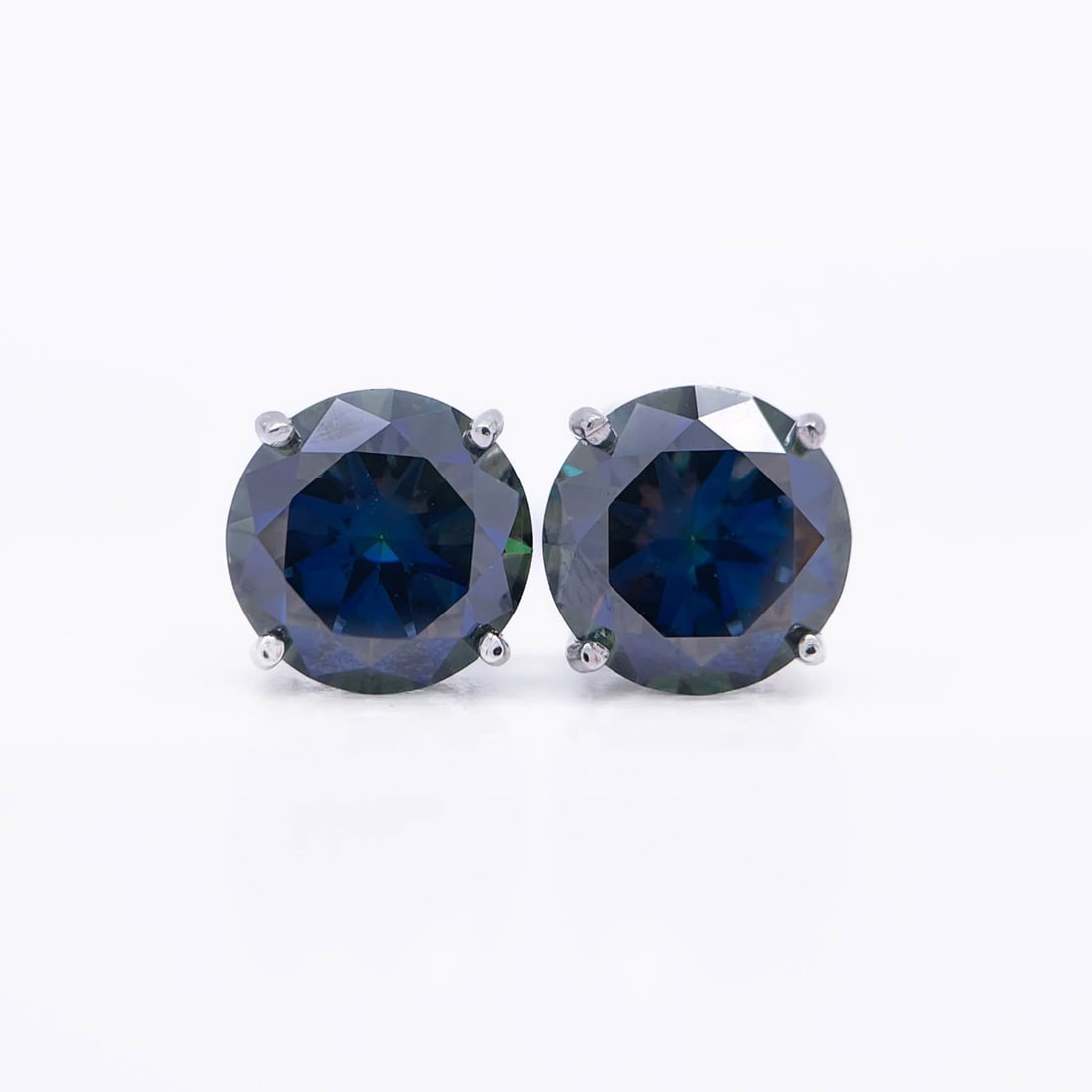 Plated 14KT White Gold 4.00ctw Deep Purple Moissanite Earrings: These Beautiful Large 4 Cttw Deep Purple Fire Moissanite Earrings are eye clean and bursting out with a full spectrum of Colors. They are Brilliant Round Cuts Measuring Approx 8 mm each and mounted in