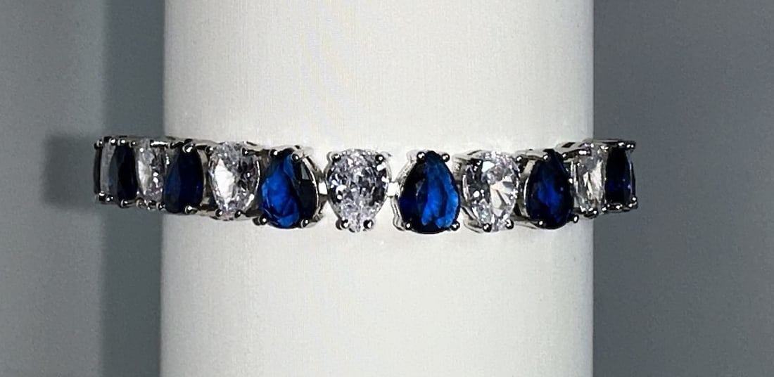 Plated 18KT White Gold 32.5 Cwt. Simulated Sapphire and Diamond Tennis Bracelet: 18 Kt. White Gold Plated 32.5 Cwt. Simulated Sapphire and Diamond Tennis Bracelet These 26 Individual Lab Simulated Diamonds and Sapphires are Pear Cuts measuring approx. 6 x 8 mm. each. They are moun