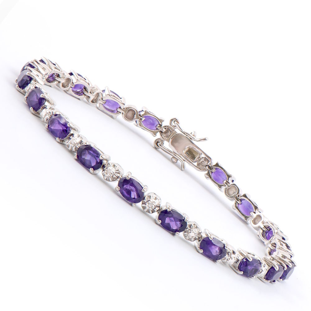Plated Rhodium 7.45ctw Amethyst and Diamond Bracelet: One Plated Rhodium 7.45ctw Amethyst and Diamond Bracelet. (20) Amethyst stones with a total weight of 7.45cts. Diamonds with a total weight of 0.02cts with a color of I-J and clarity of I-3. Total wei