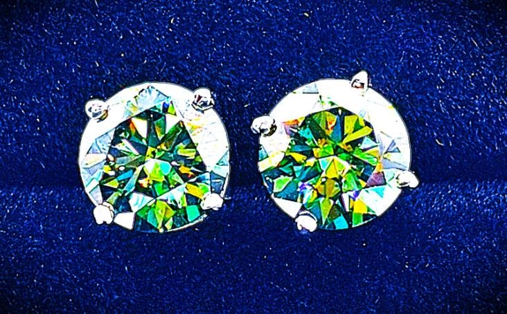 Sparkling 4 Ct VVs1 Emerald Green Fire Moissanite Earrings: These Beautiful VVS1 Moissanite Earrings Are Near Flawless and bursting out with a full spectrum of colors. The Color is a sparkling emerald green. They are Brilliant Round Cuts Measuring Approx 8mm e