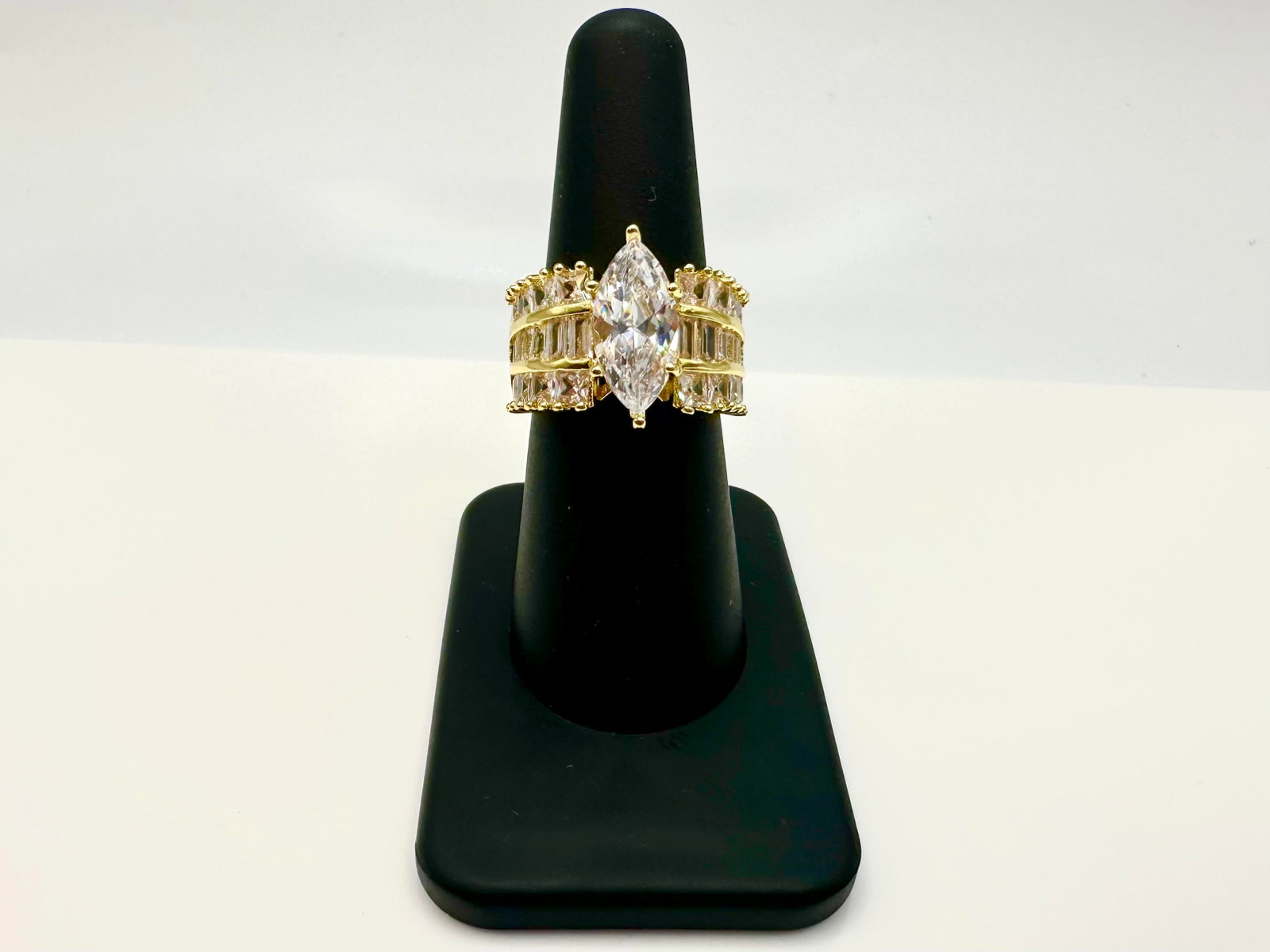 Sparkling 14 Kt Yellow Gold Plated 4.5 Ct Marquis Cut Lab Simulated Diamond Ring: Sparkling 14 Kt Yellow Gold Plated 4.5 Ct Marquis Cut Lab Simulated Diamond Ring. This 4.5 Ct VVs1 Eye Clean Marquis Cut Centerstone measures approx 15 x 7 mm. and is complimented by 12 Fancy Baguette