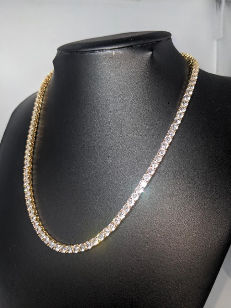 18 K Yellow Plated 36 Ctw Simulated Diamond Tennis Necklace: Sparkling 18 Kt. Yellow Gold Plated 36 Ctw Simulated Diamond Tennis Necklace. These 94 Individual Simulated Diamonds are? Eye-Clean and White in color. They are Brilliant Round Cuts Measuring 5 mm. ea