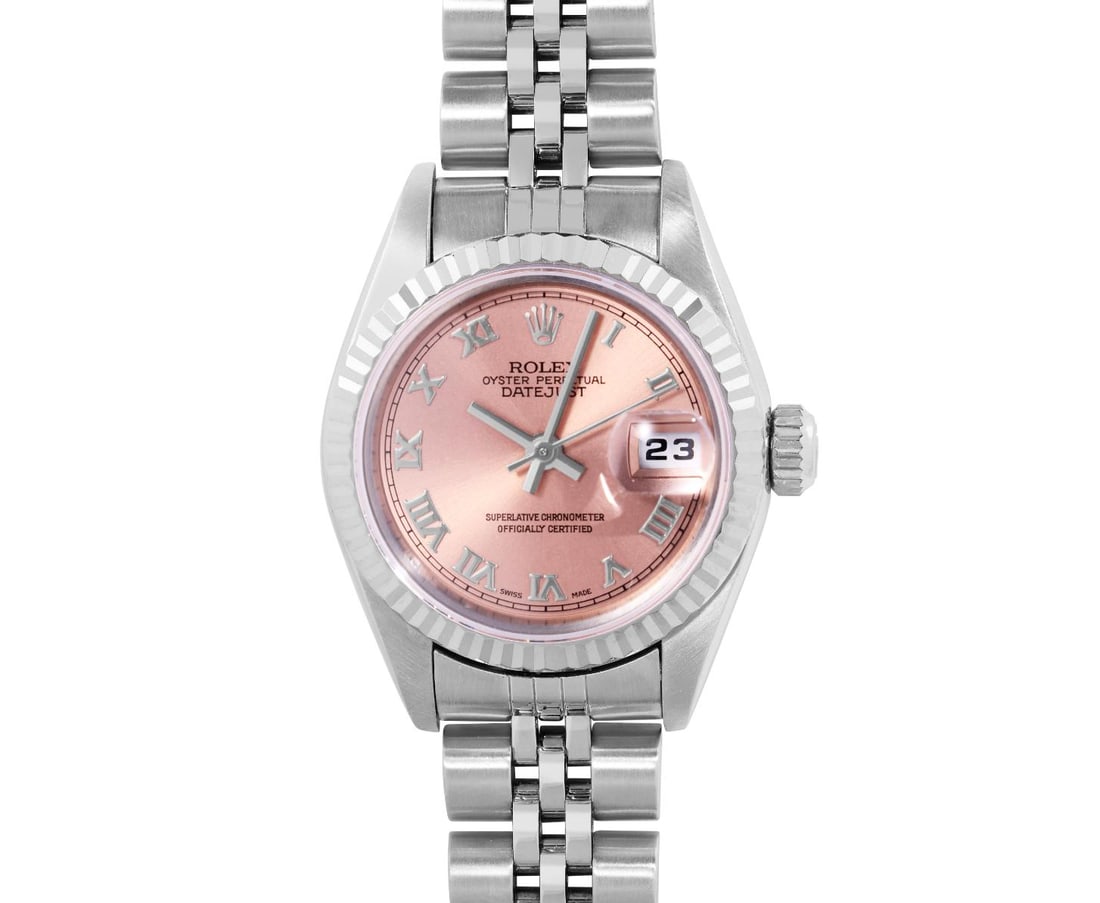 Rolex Ladies Stainless Steel Salmon Roman 18K White Gold Fluted Quickset Datejust Watch: This Lady Rolex Quickset Datejust watch features a salmon dial with roman hour markers and a sapphire crystal, with a magnified date window. The timepiece has a Rolex 18k white gold fluted bezel. The 