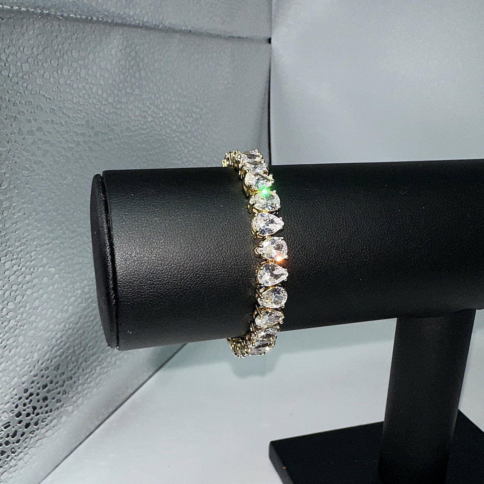 18 Kt Yellow Gold Plated 32.5 Ctw Simulated Diamond Tennis Bracelet: Stunning 18 Kt Gold Plated Huge 32.5 Ctw Simulated Diamond Tennis Bracelet. These 26 Individual Simulated Diamonds are Eye-Clean Pear Cuts measuring appox 6 x 8 mm. each. They are mounted in 18 Kt Yel