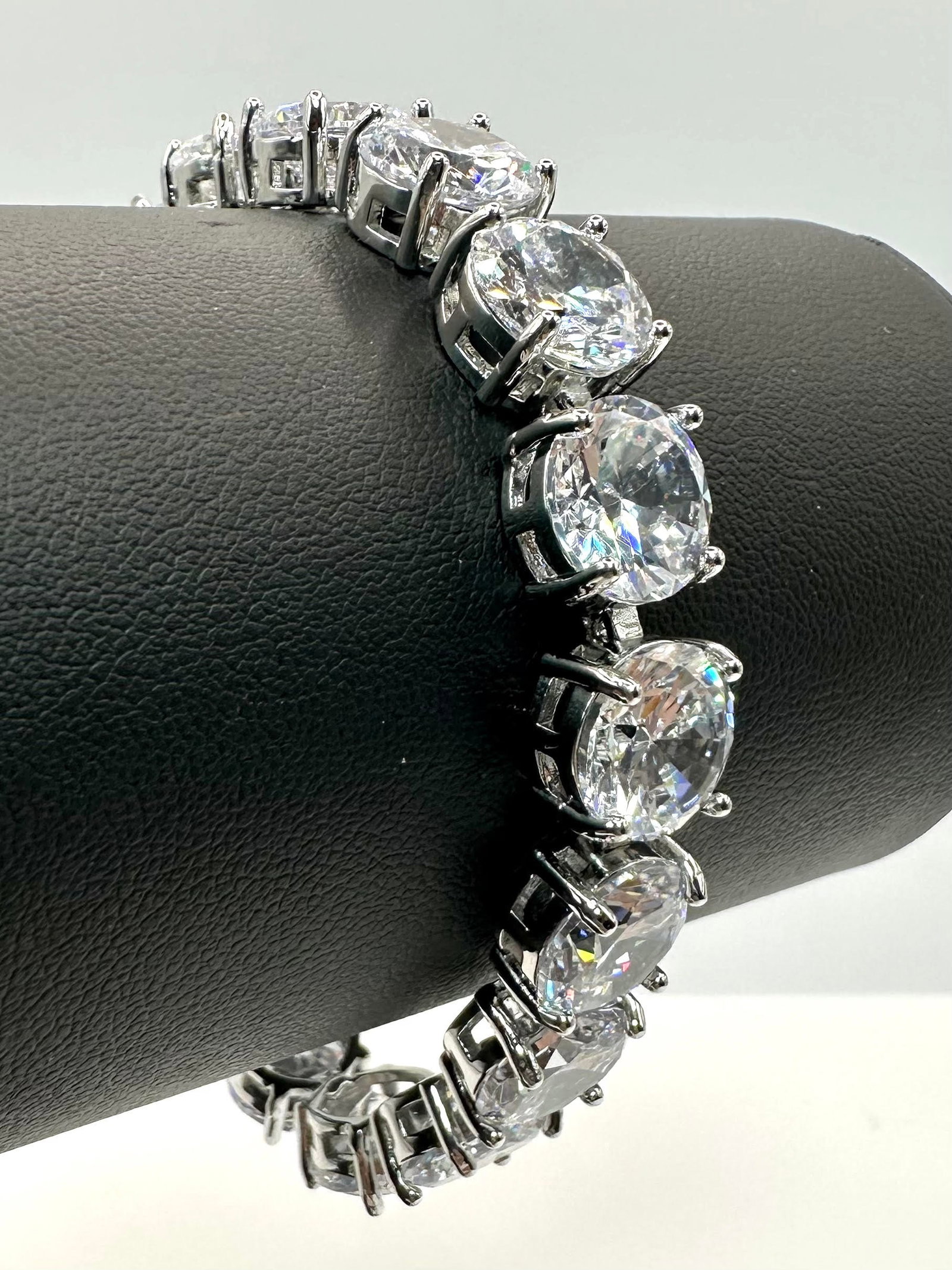 Sparkling White Gold Plate 58 Cttw Simulated Diamond Tennis Bracelet: Sparkling White Gold Plate 58 Cttw Simulated Vs1 Diamond Tennis Bracelet. These 17 Gemstones are Brilliant Round Cuts Measuring 9.5 mm. They are Mounted In?14 K White Gold Plate. Approx. 7" long.
