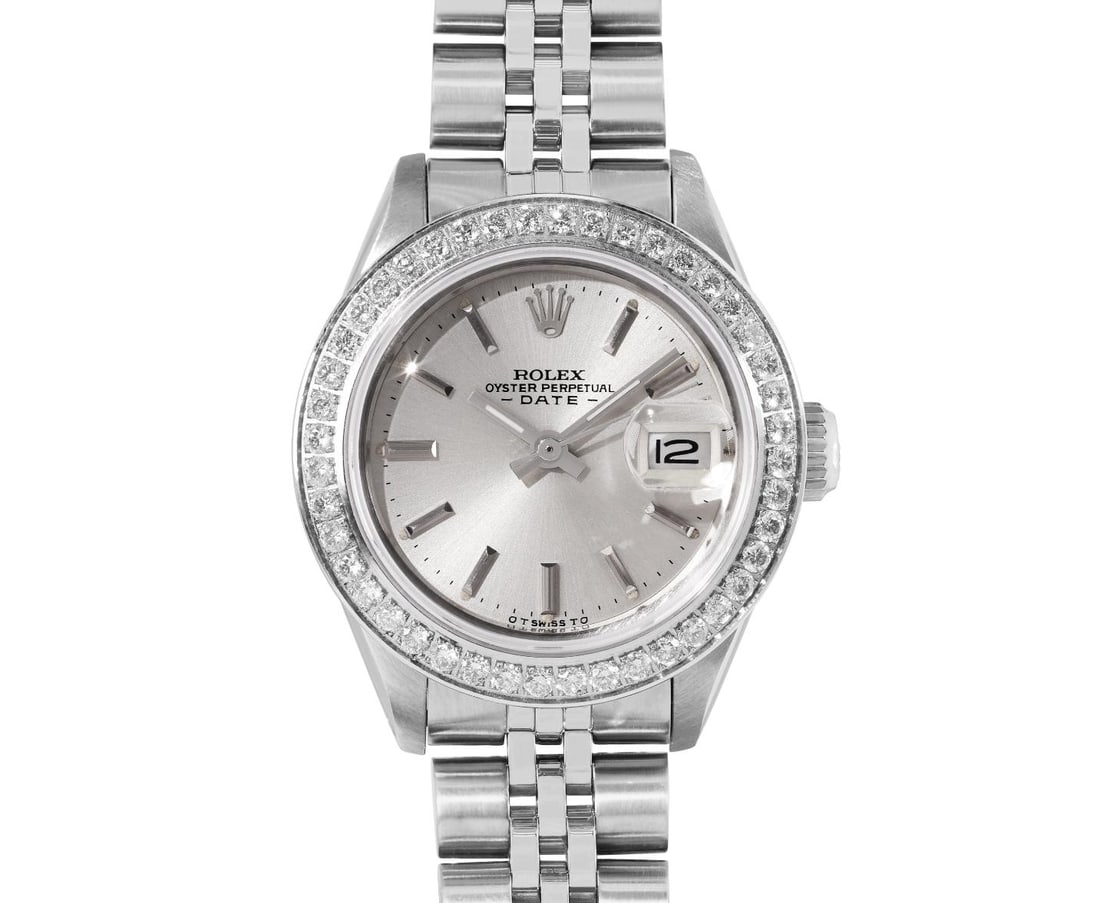 Rolex Ladies Stainless Steel Diamond Bezel Date Watch: This Lady Rolex Date watch features a silver dial with index hour markers and a custom sapphire crystal, with a magnified date window. The timepiece has a custom stainless diamond bezel, set with genu