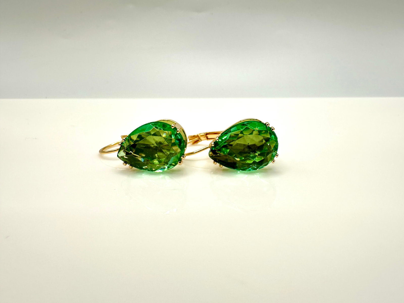 Plated 14KT Yellow Gold 16ct Bright Simulated Paraiba Tourmaline Earrings: These incredible bright 16 Cttw simulated Paraiba gemstones are both VVs1 eye-clean pear cuts measuring 12 x 17 mm. They are both set in 14 Kt Yellow Gold Plate. The total gram weight for the pair is 