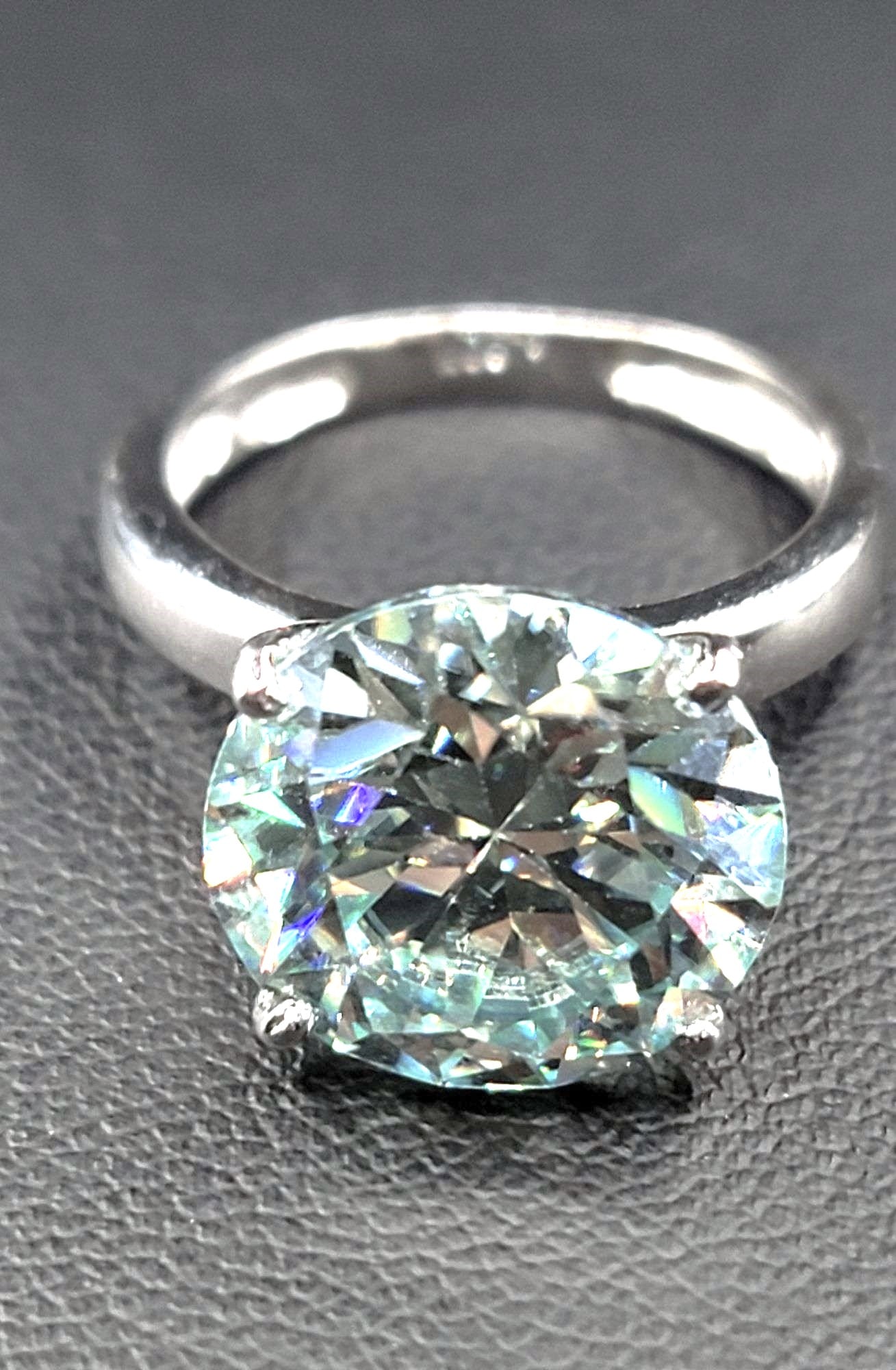 Plated 14KT White Gold 7.25ct Vvs1 Ice Blue Fire Moissanite Ring: Sparkling 7.25 Ct Ice Blue Fire Moissanite Solitaire Ring. This Exceptional Fire Moissanite is a VVs1 Brilliant 12 mm. Round Cut. The Color is Ice Green and is near flawless bursting out with a full s