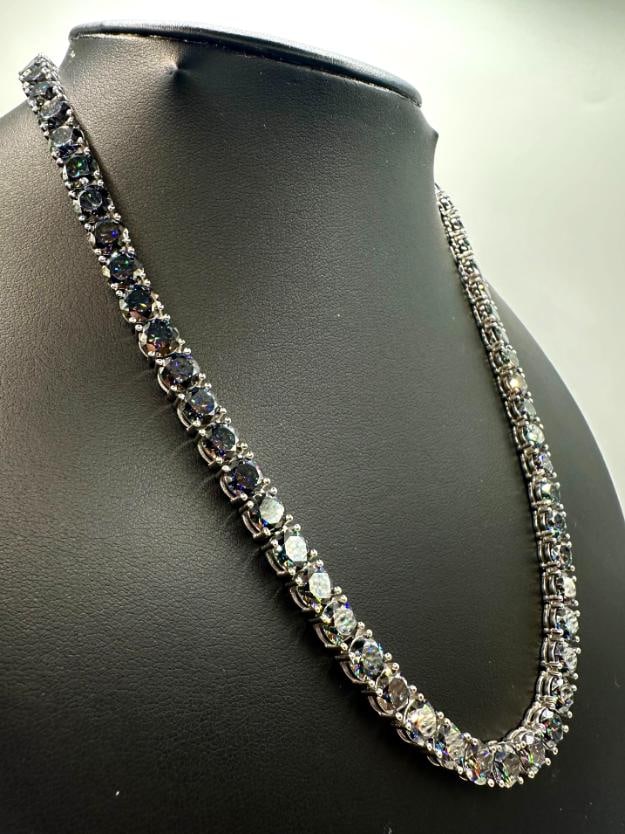 18KT White Gold Plated 69ctw Deep Purple Fire Moissanite Necklace: Dazzling 18Kt White Gold Plate 69 Cttw Deep Purple Fire Moissanite Diamond Necklace. These 69 Individual Moissanites are VVs1 Clarity and a very Vibrant Deep Purple and Deep Emerald Green in Color. Th