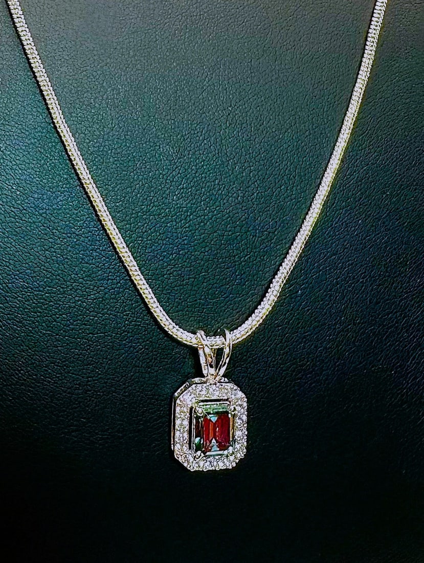 3.5 Cwt. Emerald Green Fire Moissanite Pendant: This 3.5 Cwt. Fire Moissanite Center-Stone is mounted in 14 Kt. White Gold over Solid .925 Sterling Silver. With a refractive index of 2.65-2.69, this gemstones exhibit more brilliance than a natural 