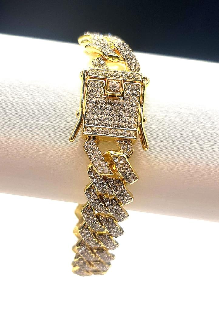Impressive 40.1 Gram 14Kt Yellow Gold Plated Miami Link Bracelet: Dazzling 14 Kt Tri-Layered Gold Plated Bracelet is complimented with Sparkling Clear Accent Stones. This High Quality Top Notch Bracelet is a Stealth 12 mm. Wide and 8.5 " in length. This Bracelet Is 