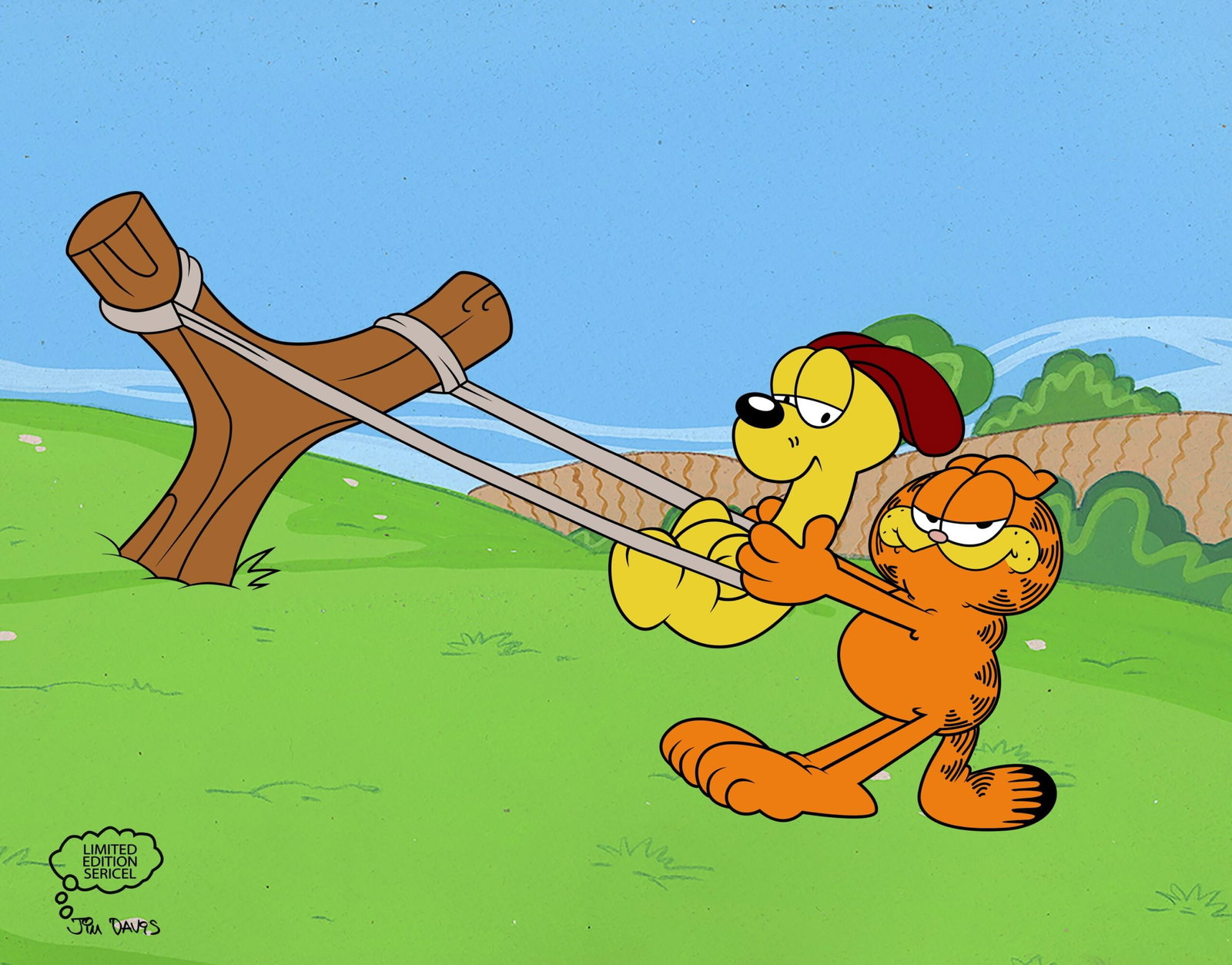 GARFIELD & ODIE Sericel Animation Art Cel: This is a limited edition sericel of Jim Davis Garfield titled Mind Over Matter This image features Garfield pulling Odie in a slingshot. This Cel measures 11 inches x 14 inches, comes unframed, in ex