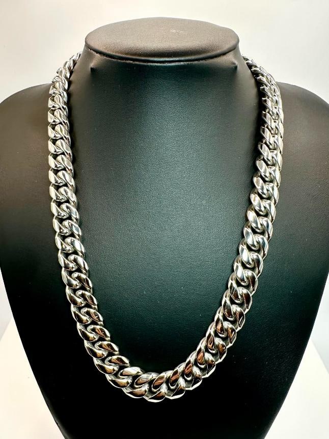 203.5 Gram 14 Kt White Gold Plate Cuban Link Chain Necklace: Huge 203.5 Gram 14 Kt White Gold-Plated Cuban Link Necklace.?This necklace is 20 inches long and is a thick 14 mm wide. Secured with a Double Safety Clasp. This necklace weighs in at a Stealth 203.5
