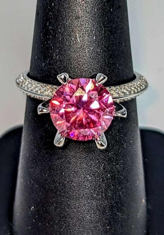 Ladies Sparkling 5 Ct Bright Pink Simulated Lab Diamond Ring: This Huge 5 Ct Lab Simulated Diamond Solitaire is an Eye-Clean Brilliant Round Cut Measuring 11 mm. The Color is a Vibrant Rose Pink. This center-stone is complimented by 124 clear faceted accent ston