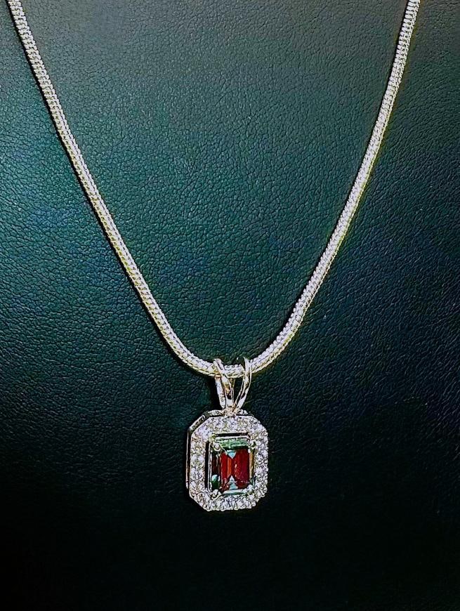 Sparkling 2.25 Ct VVs1 Emerald Green Lab Simulated Diamond Pendant: This 2.25 Ct Lab Simulated Diamond Center-Stone is a Vvs1 Eye Clean and Emerald Green in Color.? It is an Emerald Cut mounted in 14 Kt Tri-Layered White Gold over Solid .925 Sterling Silver. With a