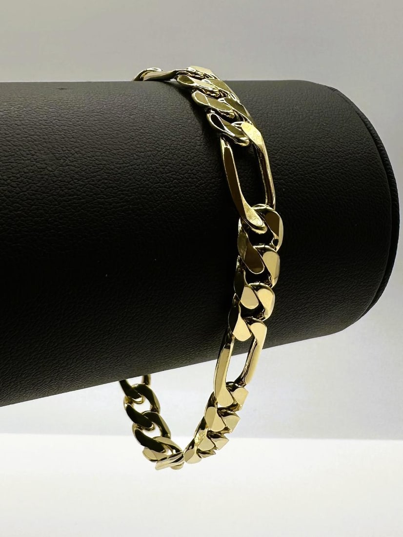 Sharp 12.2 Gram 14 Kt Yellow Gold Plate Italian Figaro Bracelet Bracelet: Sharp 12.2 Gram 14 Kt Yellow Gold Plate Italian Figaro Bracelet. This bracelet measures 7 mm. wide and is 8" in length. It looks like solid gold without the solid gold price. This Bracelet Is Strong!