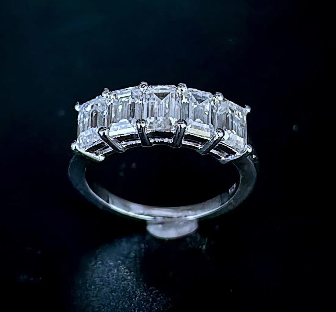 5.07 Ct VVs1 White D-E Fire Moissanite Ring: These 5 Emerald Cut Moissanites are VVs1 Clarity and D-E in color measuring approx. 6.5 x 4.5 mm. These investment grade Moissanites are near flawless and bursting out with a full spectrum of colors. 