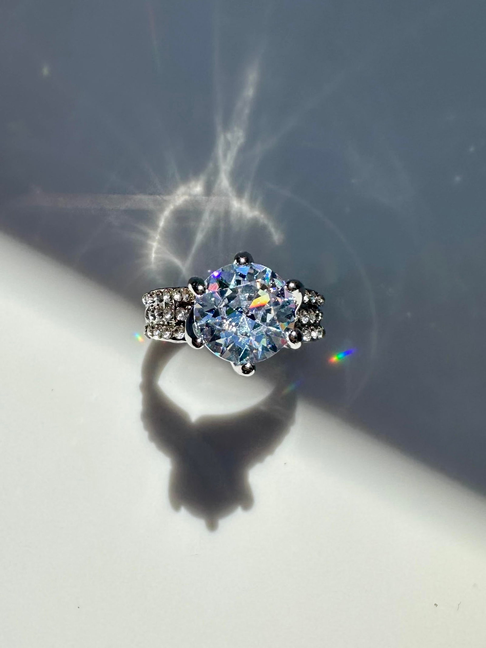 14 K White Gold Plated 3.5 Ct VVs1 Simulated Diamond Ring: This Large 3.5 Ct Simulated Diamond Center-Stone is a Brilliant Round Cut Measuring 10 mm. The Color is Bright White and It is eye clean bursting out with a full spectrum of colors. It Is Mounted In 1