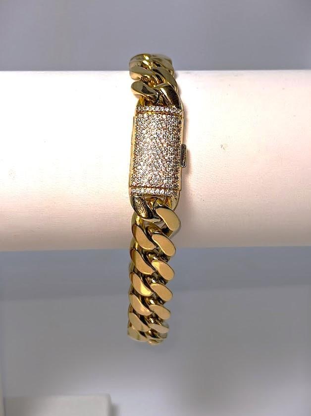 Huge 50 Gram Yellow 14 Kt Gold Plate Cuban Curb Link Bracelet: This Top Notch 50 Gram 14 Kt Gold Plated Bracelet Measures A Stealth 12 mm. Wide and 9" Long. This bracelet is highlighted with a 1 Cwt. Simulated Diamond Clasp. 9.6 Total Grams.