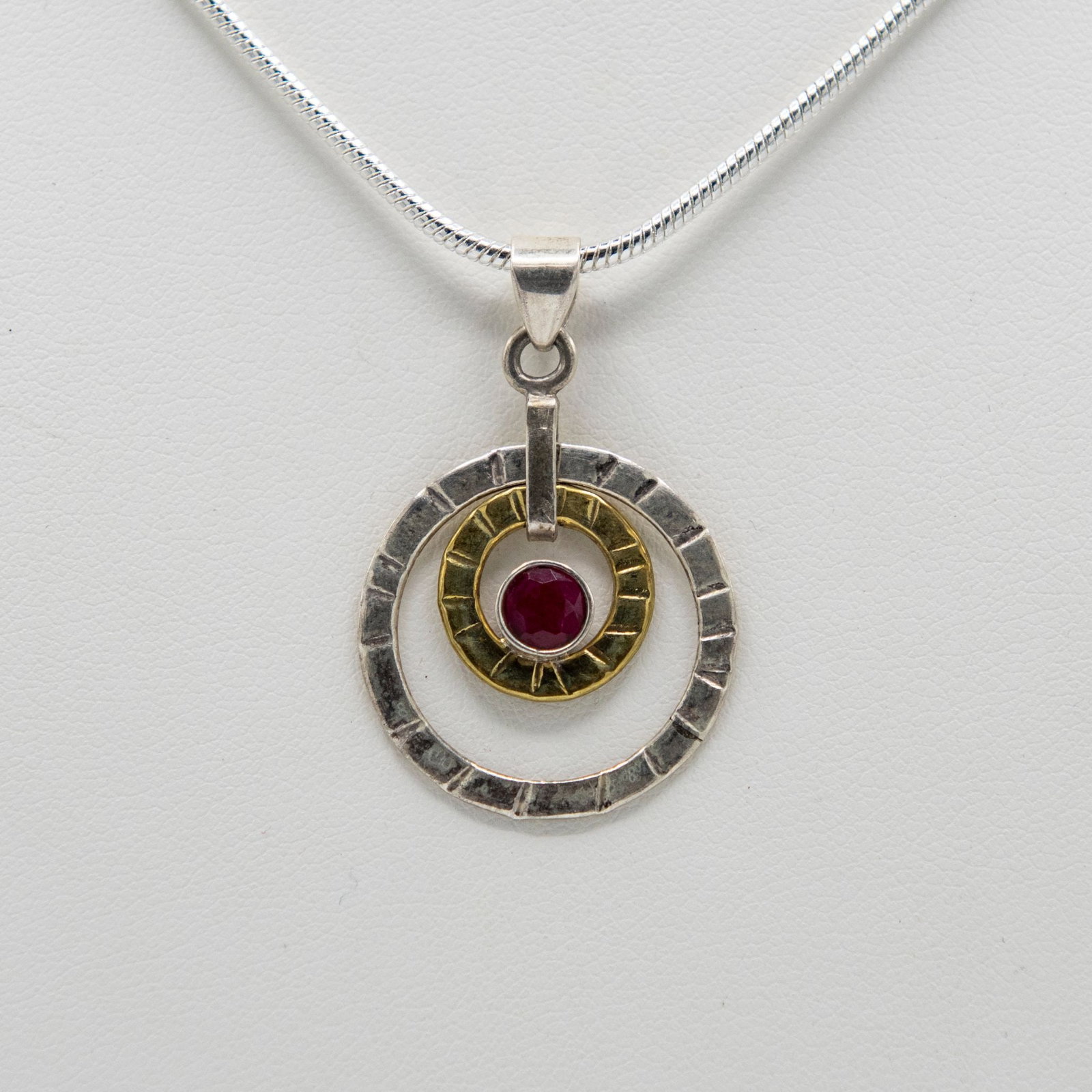 Outstanding 1 Ct Sterling Silver Ruby Pendant: Outstanding 1 Ct Sterling Silver Ruby Pendant. Mounted In Elaboratly Designed Solis Stamped .925 Sterling Silver. Partially Accented With A 14 Kt Gold Overlay. Includes 20 " Long 2 Mm Chain 61.50 Cttw