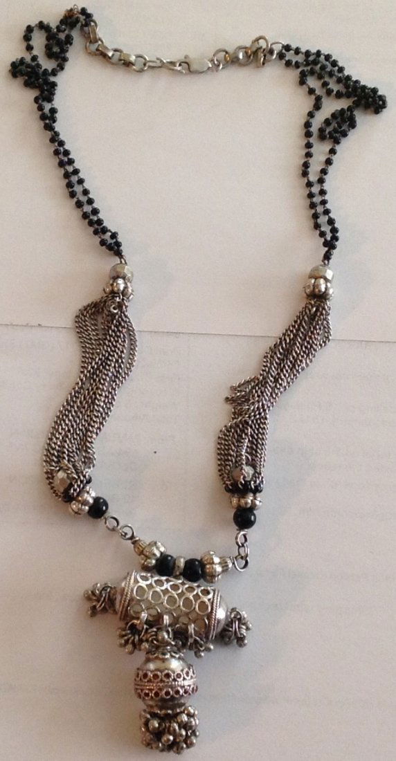 Estate vintage sterling ornate amulet pendant necklace: Estate items. Marked. 925 .Tested . 925 Clasp. And amulet . Size. 20 inch. Weight . 35.6 grams. Copper repair on chin, mini onyx like beads. Mixed metals, Some enamel work.