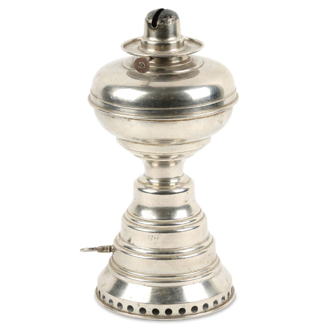 Scarce Mechanical Wanzer Oil Lamp: Burner ring marked 'Wanzer Lamp Co. Niagara Falls U.S.A. Pat. 1887, nickel plated finish, spring working, 12" high. Condition: Perfect