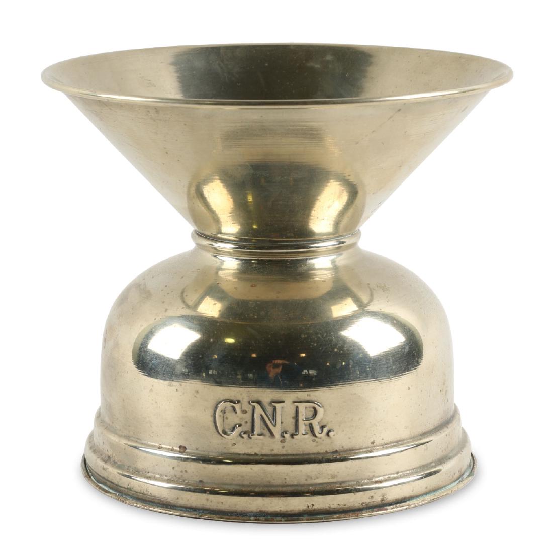 Canadian National Railway Spittoon: Polished nickel composition with weighted base. Embossed "C.N.R to outer body. Condition: Very Good. Minor uniform surface oxidization. 8.5" x 7.25".
