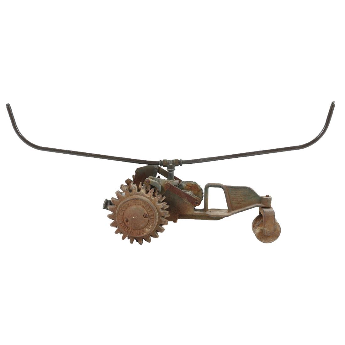 Cast Iron "Walking Tractor" Sprinkler: Made in Vancouver Canada. Painted cast with brass fittings. Condition: Complete. Oxidization, fading. 36" x 8" x 9 .5".