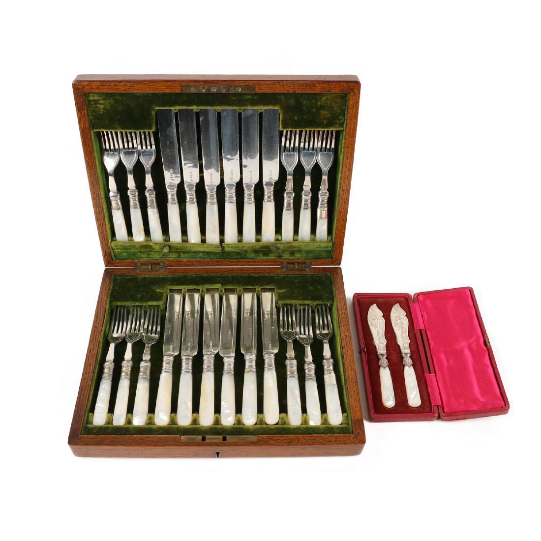 Cased Silverplate Cutlery Sets: Lot 153 - Two (2) complete sets. One quarter-sawn oak case. Velvet-lined cases complete with silverplated forks and knives. Larger set marked "Henry Rogers, Sons & Co.". Mother of pearl, bone handles.