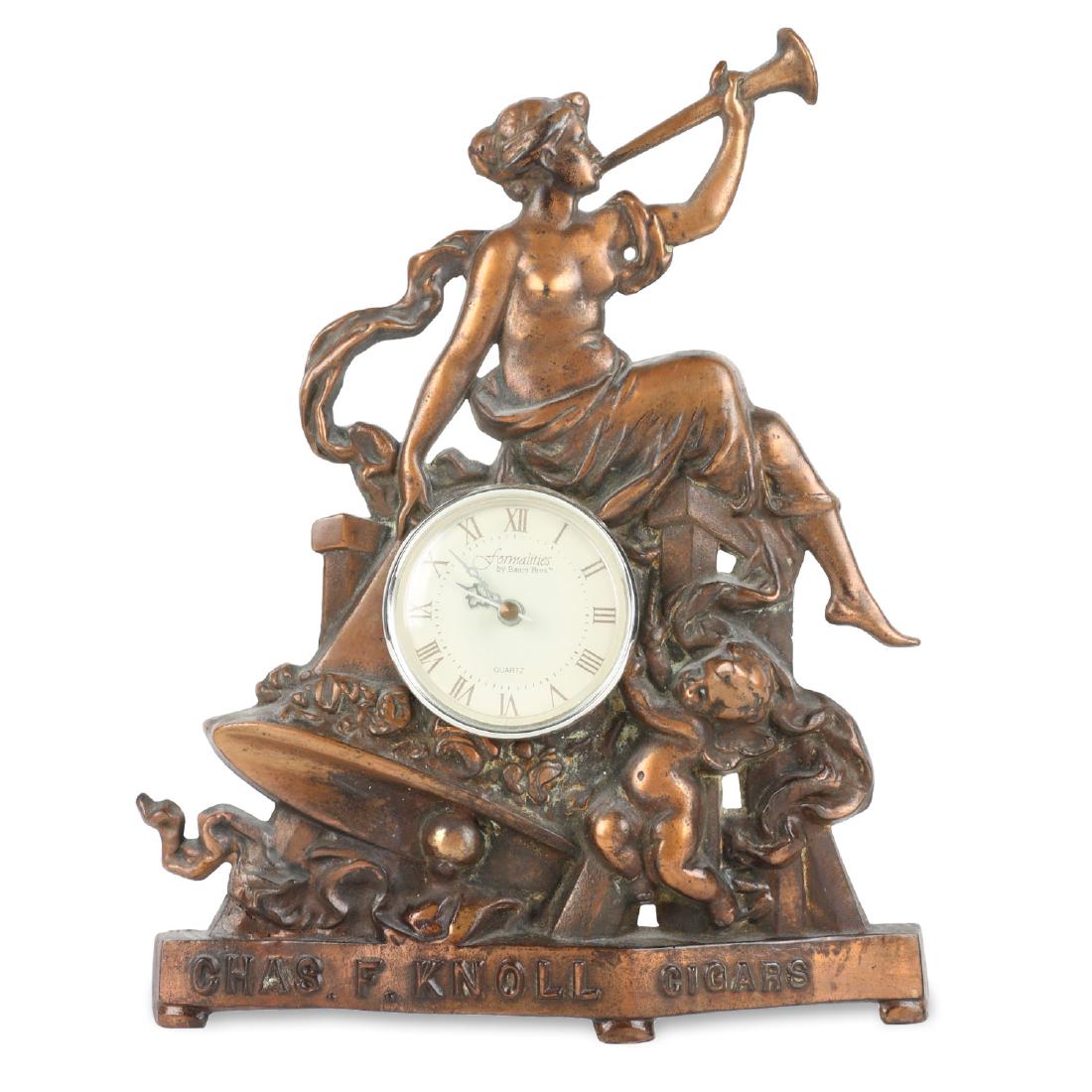 Chas. F. Knoll Cigars Cast Clock: Cast iron. American. Replacement clock. 12.5â€ x 9.5â€ x 3â€. Professional restoration to cast, lower left corner. Replacement clock. $300-500.