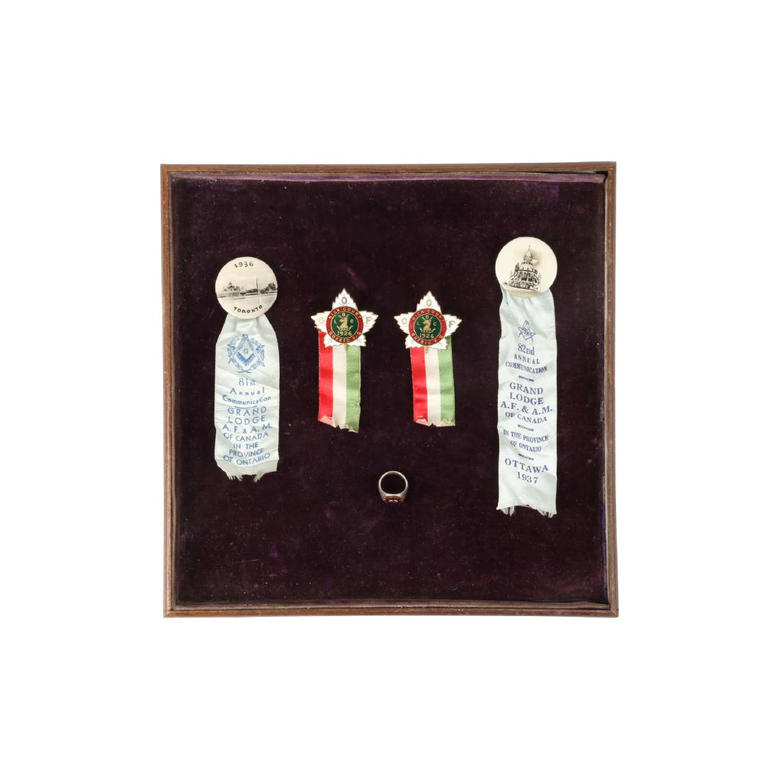 Canadian Fraternal Organization Memorabilia: Six (6) items. Two (2) celluloid pinbacks with ribbons, two (2) enamelled badges (OOF), one (1) ring (Shriners) and one (1) token. .50" to 1 3/8". Two retain paper inserts. $100-200.