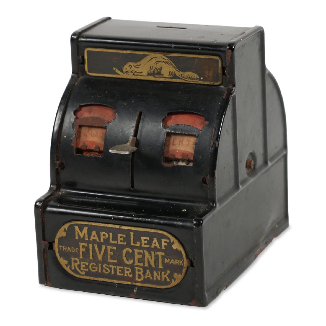 Canadian Tin Litho Coin Bank: Marked, "Maple Leaf Register". Bell sounds when lever pushed. 4.5" x 4.5" x 3.5". Surface flaking. Stain to paper inserts. Missing "Dollars" reader roll. $100-200.