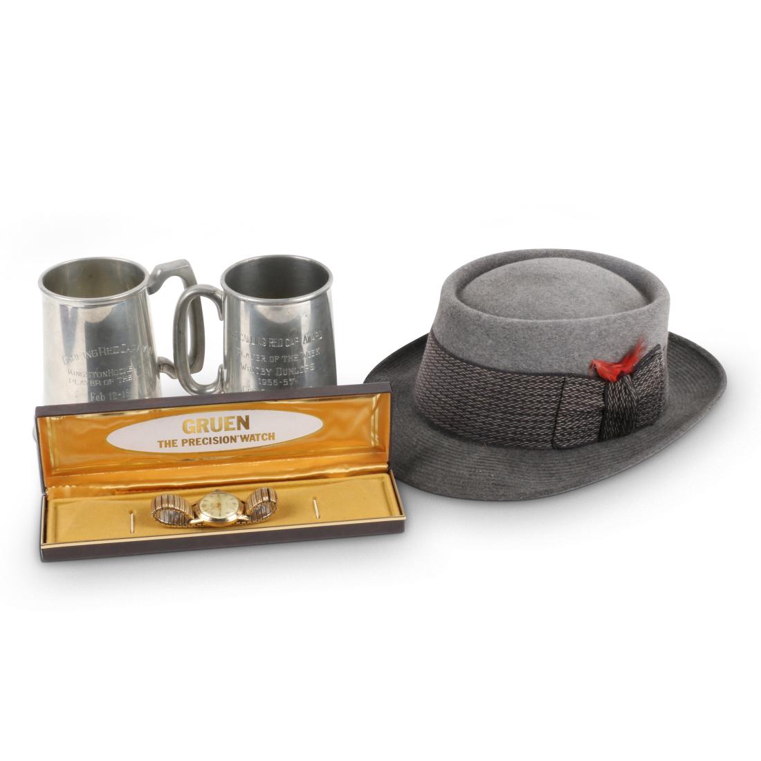 Allan Cup Watch, Hat, Mugs: Canadian. 1956-57 Champions Award Watch, Hat and Mugs. This lot includes awards presented to George Samolenko of the Whitby Dunlops upon winning the Allan Cup in the 1956-57 season. Includes a Gruen "