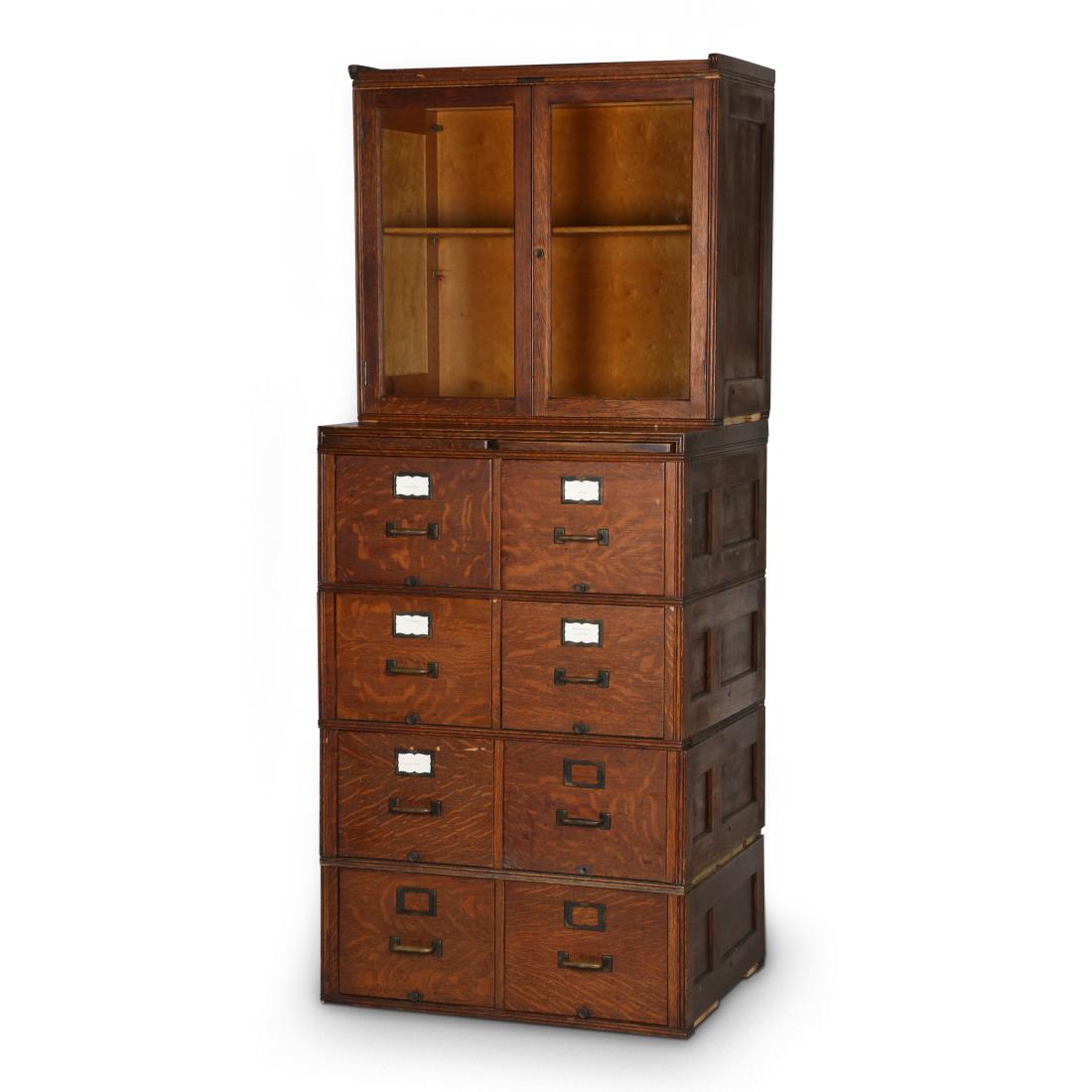 Barrister's Stacking Office Cabinet: American. Rochester, New York. C.1900. Five sections. Solid quarter-sawn oak. Upper section tagged, "Yawman & Erbe Mfg Co. Rochester NY, USA". 85.75" x 33" x 25". Original finish. Minor flakes to edge