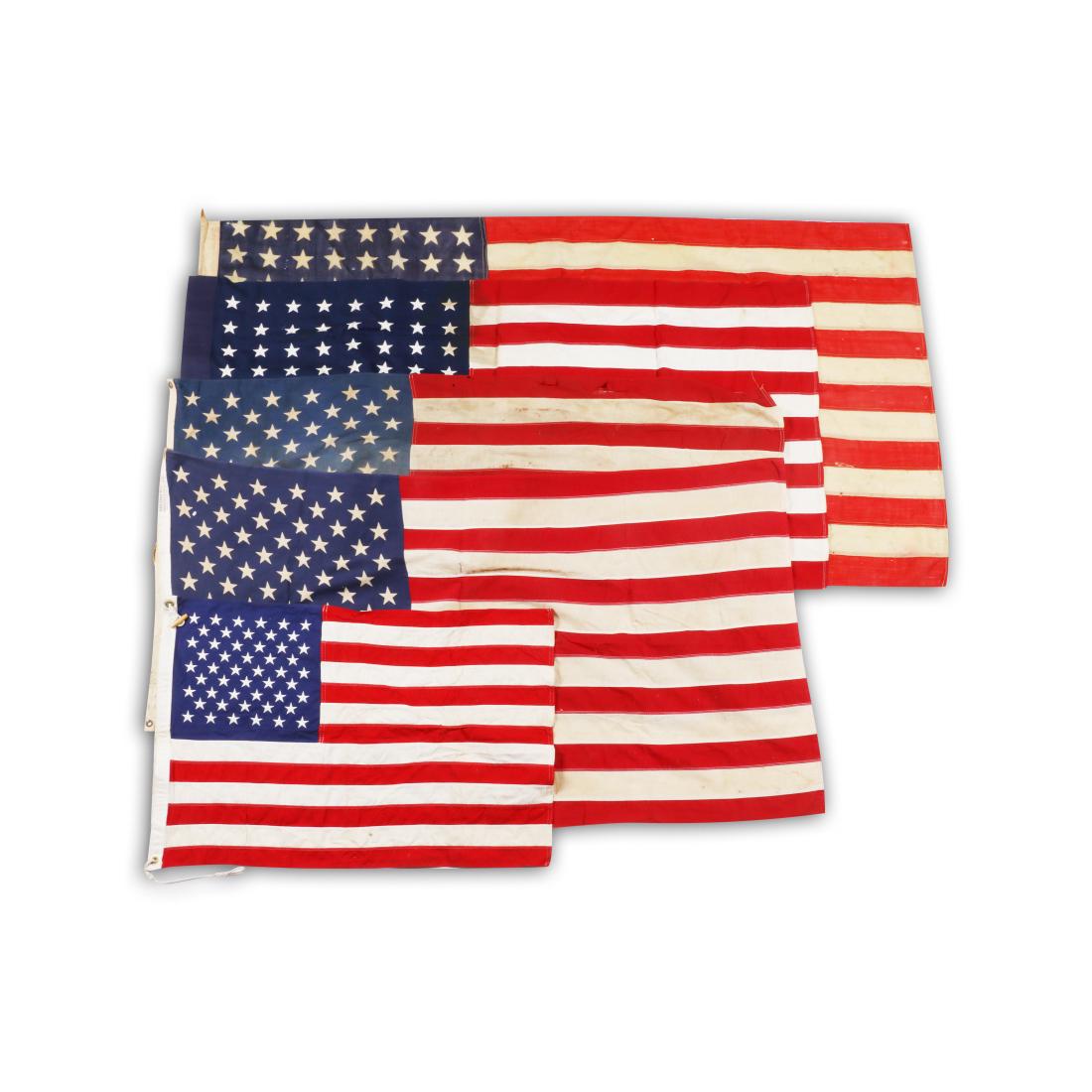 American Cotton Flags: Five (5). American. 1940-70s. Some with stitched panels. 34" x 22" to 72" x 38". Good. Small rips and tears, mostly near the edges. Minor soiling and small stains. 200-300