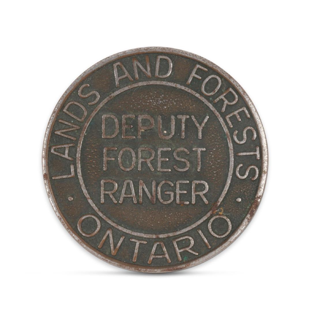 Ontario Deputy Forest Ranger Badge: Canadian. 1930s. Includes original screw-down clasp. 1.5". Very Good. Minor surface oxidation. Nickel-plating slightly worn. 50-75