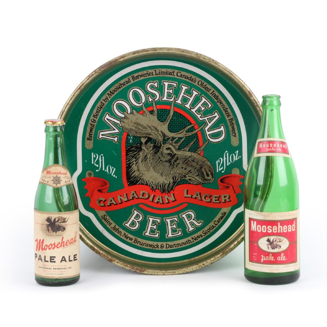 Moosehead Tray & Bottles: Three (3). Eastern Canadian. 1950s. Tallest bottle 10.5" (h); tray 13" (dia.). Very Good. Minor rim wear. Bill Kirkwood Collection. 100-200