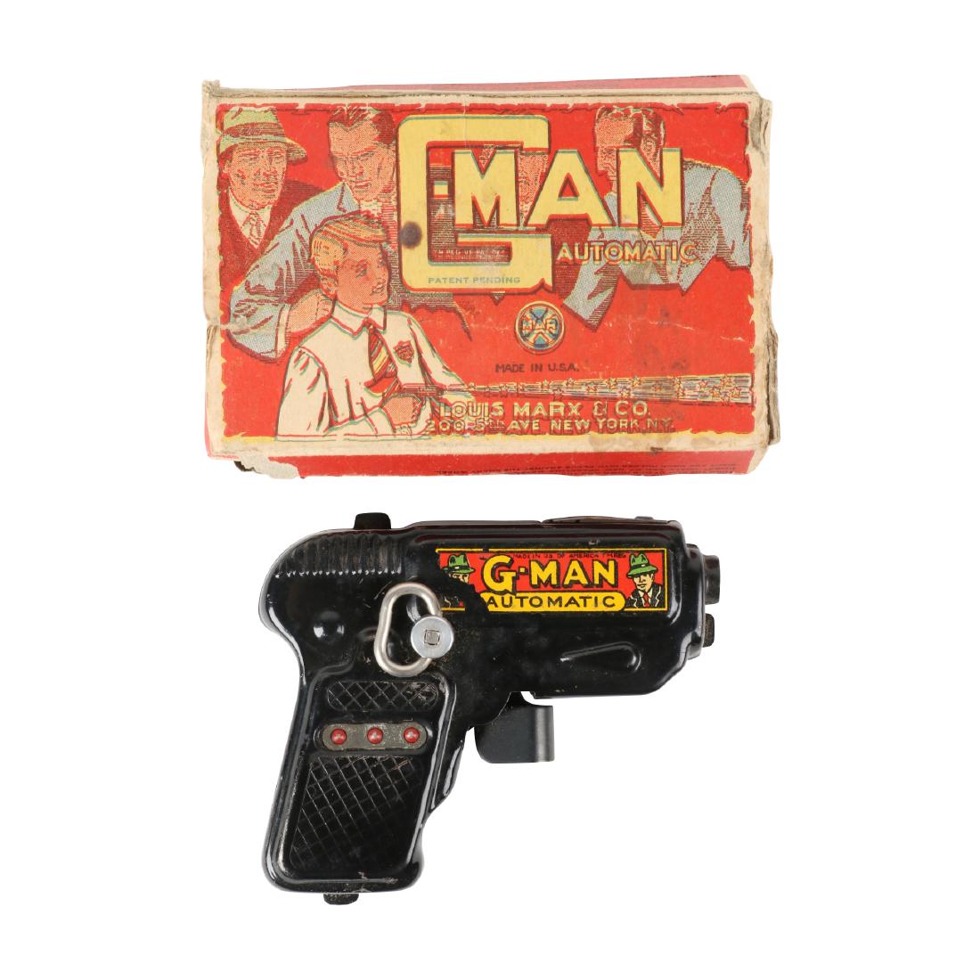 Marx G-Man Toy Pistol: American. 1950s. Offered in its original, graphic box. 4.5" x 3" x 1". 100-200.