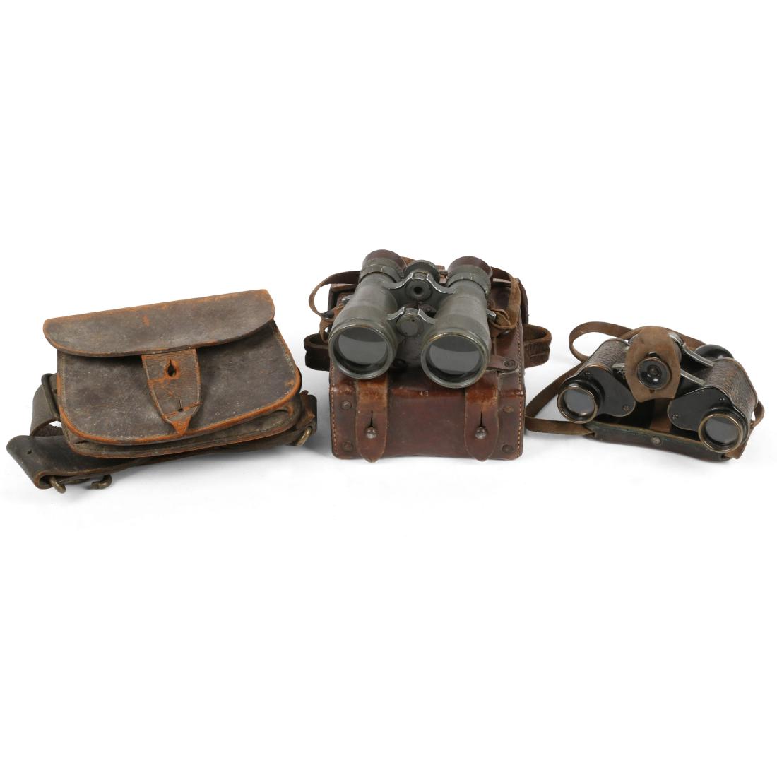 German WWII Wehrmacht Binoculars: Leather case stamped "Carl Zeiss" with label underneath lid. Binoculars inside stamped, "Fernglas 08, E. Leitz Wetzlar". Other pair stamped, "CP Goertz, Berlin" and "6x24, Armee-Trieder DRP". 5.5" x 5