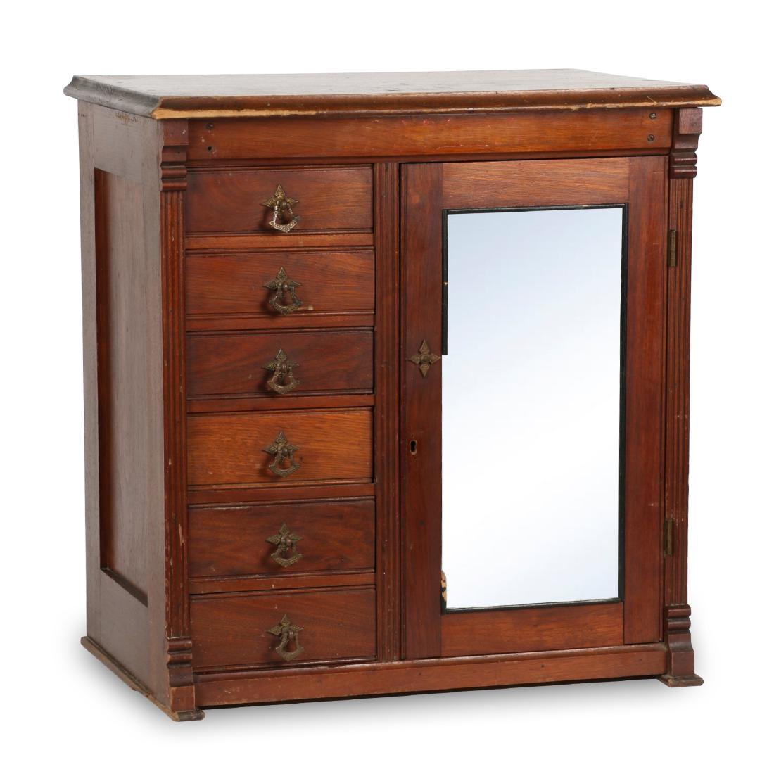 Miniature Belding Spool Cabinet: Circa 1900. Miniature Spool Cabinet manufactured by Belding Paul and Company, Montreal. Stamped, "the property of Belding Paul and Co. Montreal'". Retains original hardware. Original finish. Missing a