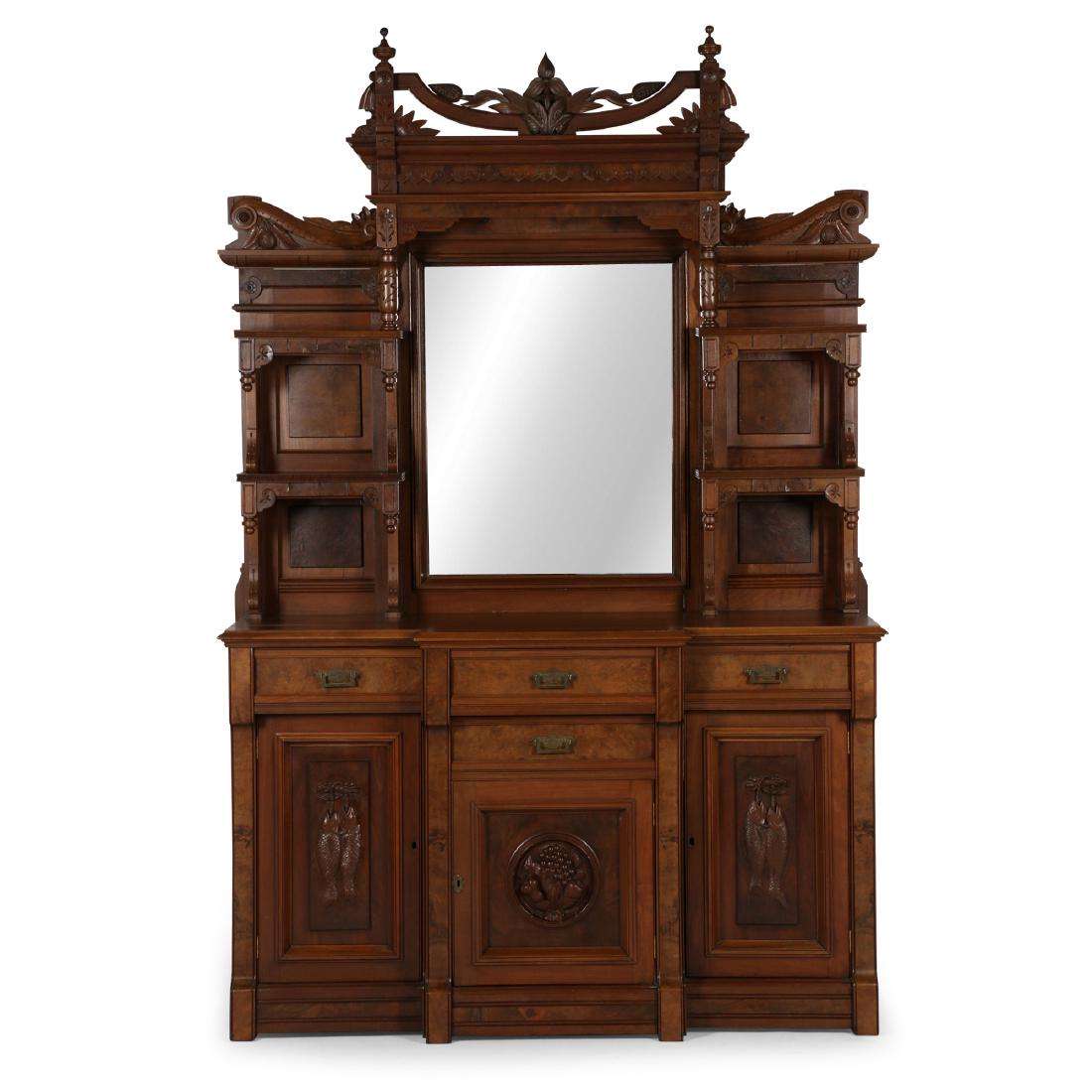 Victorian Trillium Carved Sideboard: Carved Canadian themes including trillium finial, trout carved panels, and carved fruit. Bevelled glass mirror. Raised burled panels, original cast brass hardware . 22" x 60" x 90". Professionally ref